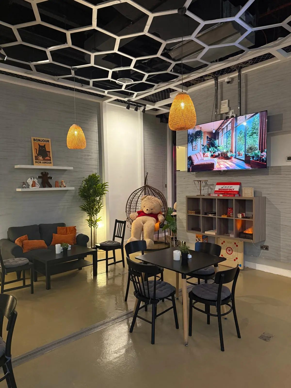 Sofas and tables under warm pendant lights at Espresso Amore, Al Thumama Mall